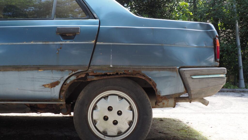 New Zealand buyer inspecting an older used car before financing it